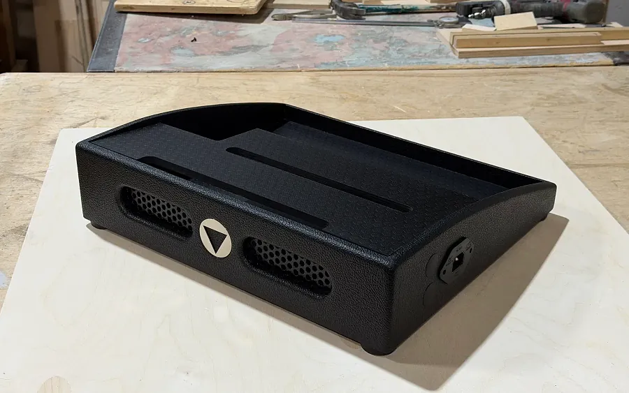 Handmade black two-deck guitar pedalboard in the builder's workshop